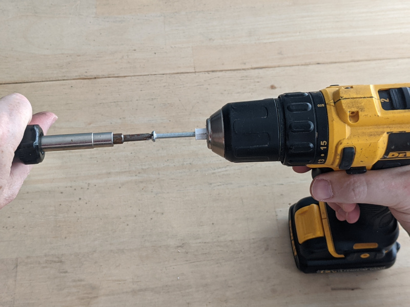 put helper in drill and use screwdriver to tap the helper tool